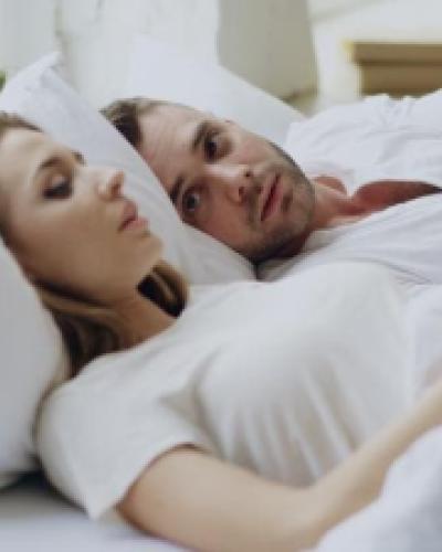 couple in bed together sharing concern